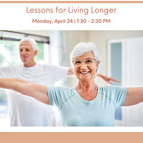 two senior adults standing with their arms in the air, smiling